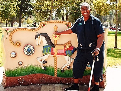 Ms Lolita standing in front of the sensory playground sign